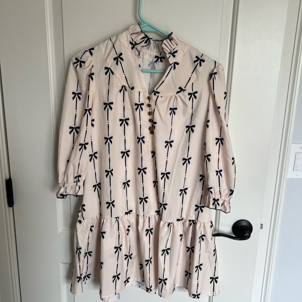 Chic Cream Dress with Black Bow Pattern